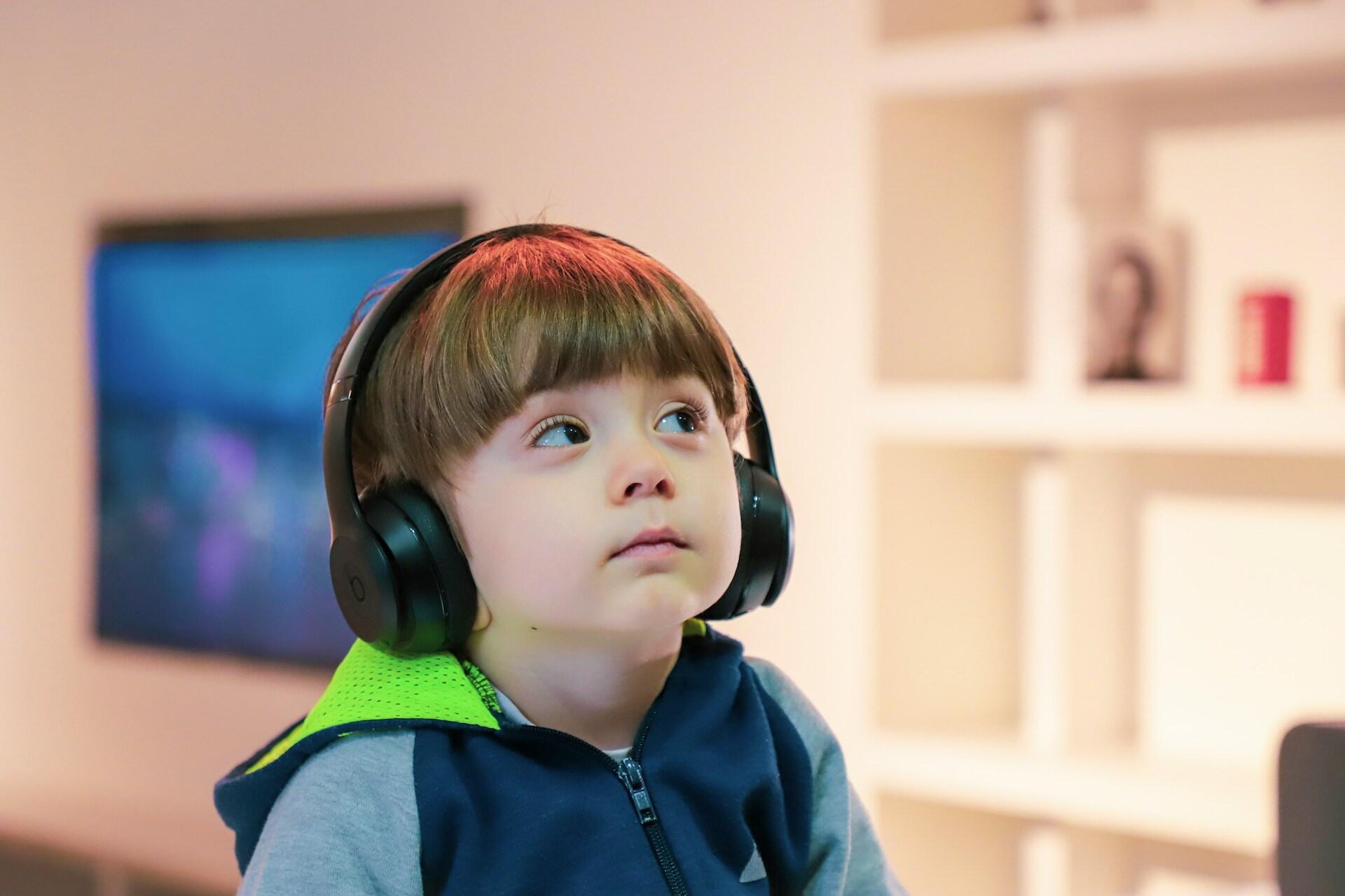 Jeune enfant qui apprend l'anglais avec un casque audio.
