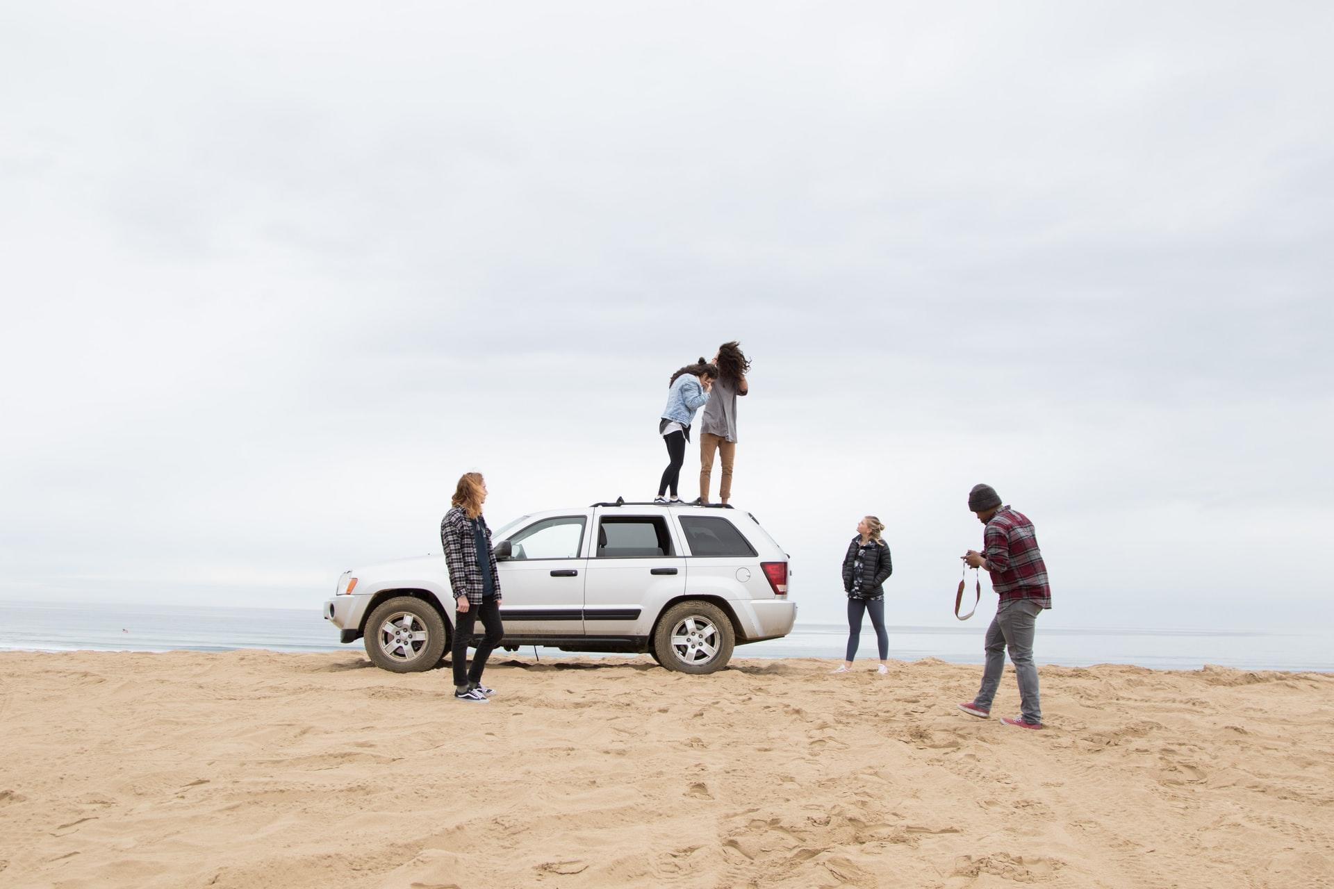 jeunes sur une voiture à la plage
