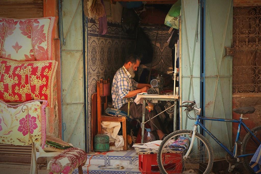 Hombre cosiendo dentro de una habitación
