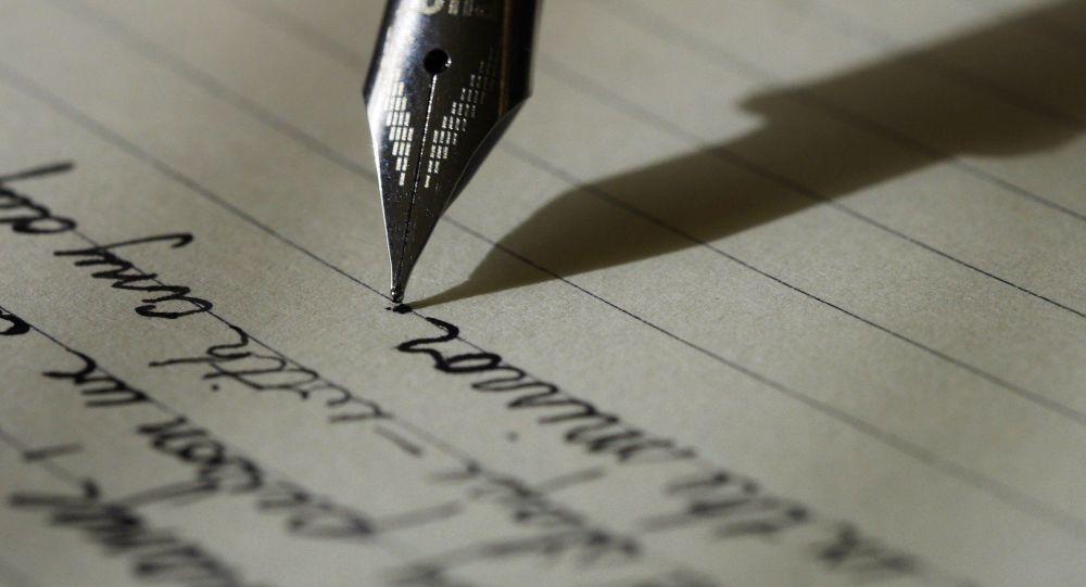 Pluma escribiendo sobre papel