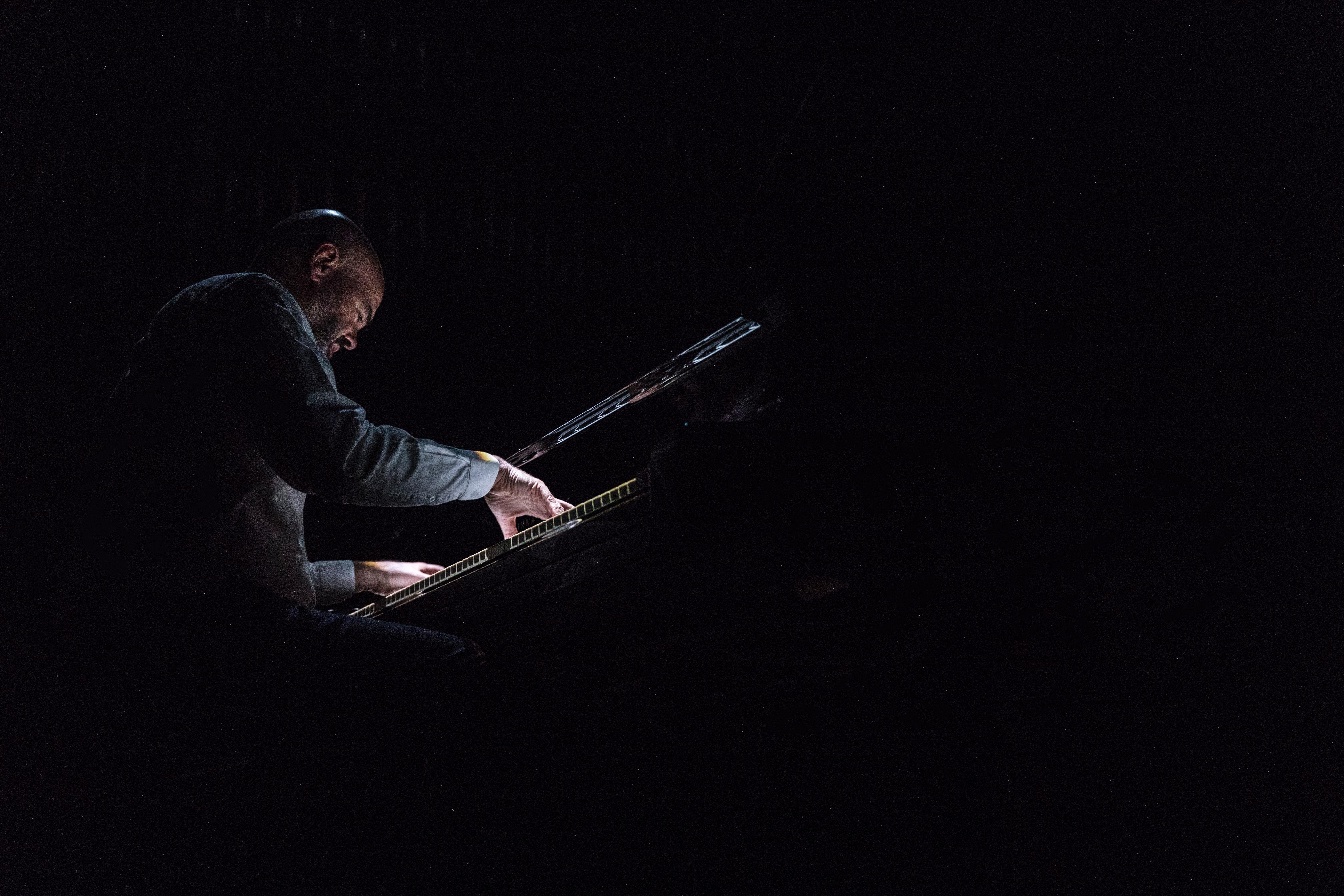 Pianista en escenario oscuro