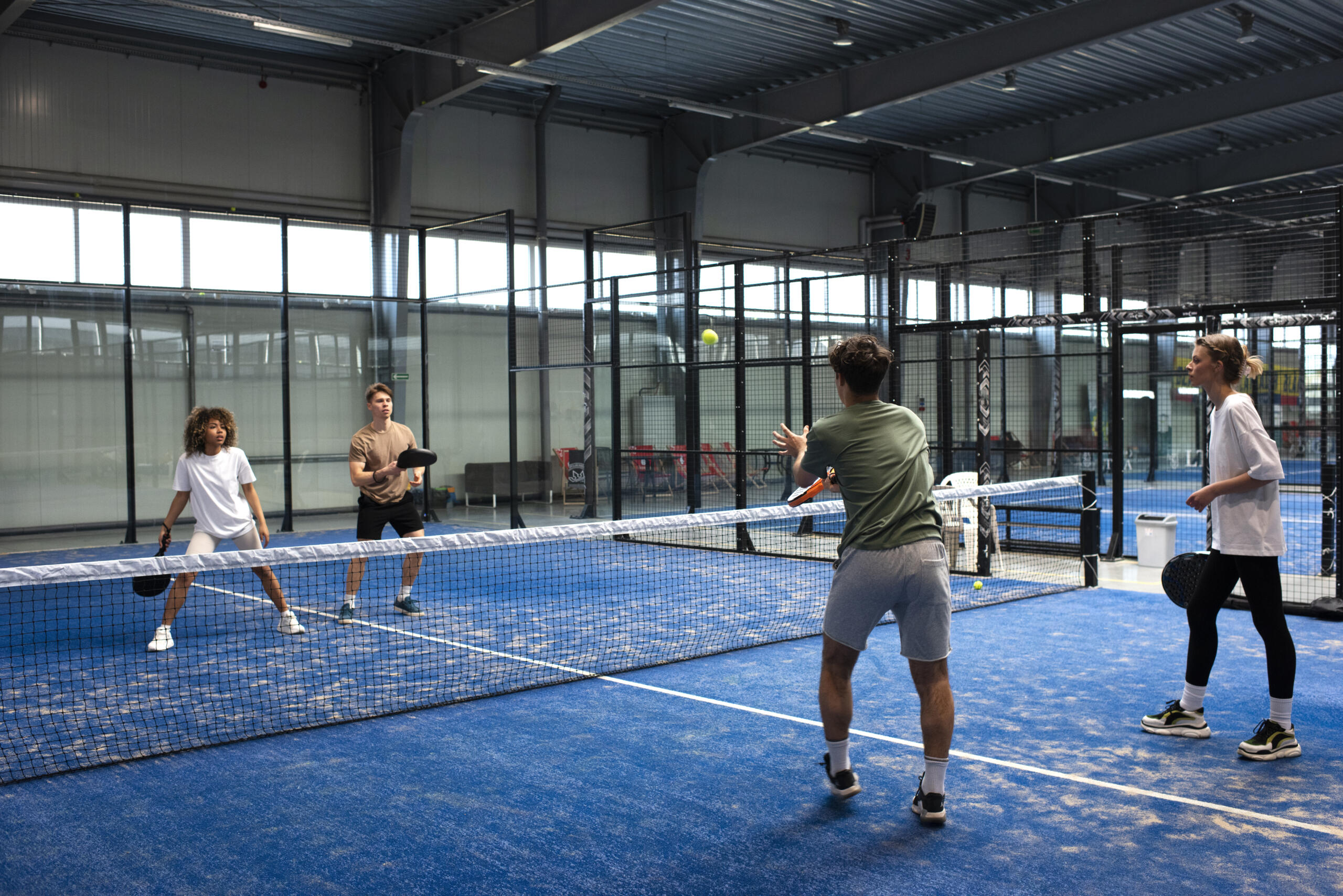 2 parejas de jugadores en cancha de padel