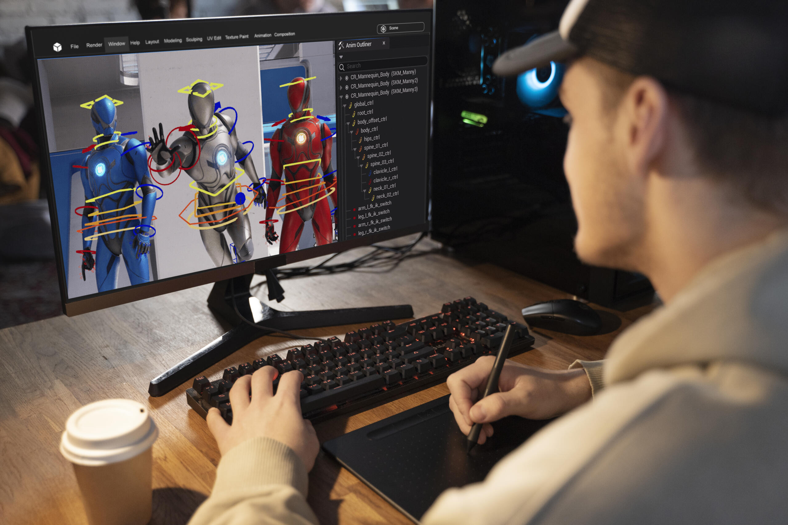 chico frente a una computadora trabajando el modelado de un personaje 3d con una wacom y teclado.
