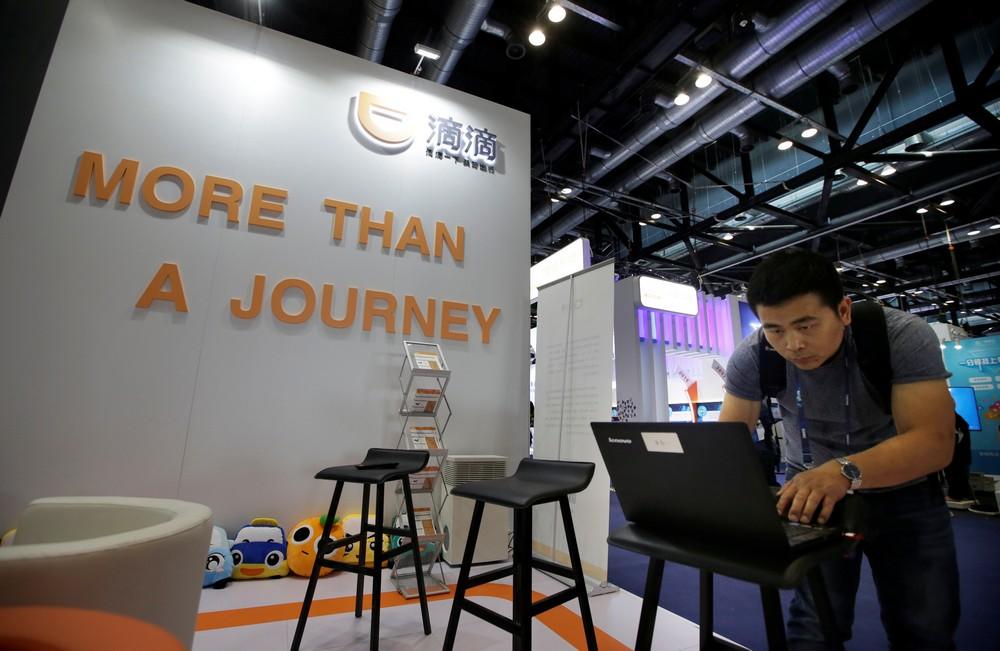 A man works at Didi Chuxing's booth at the Global Mobile Internet Conference (GMIC) 2017 in Beijing, China April 28, 2017. Jason Lee