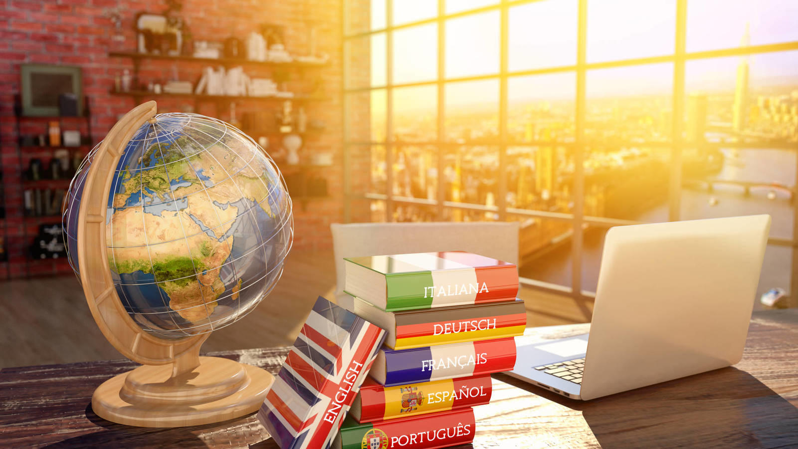 Mapa del mundo sobre una mesa junto con unos libros de idiomas