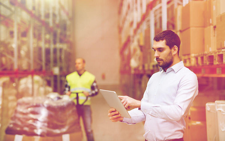 Hombre analizando stock en bodega
