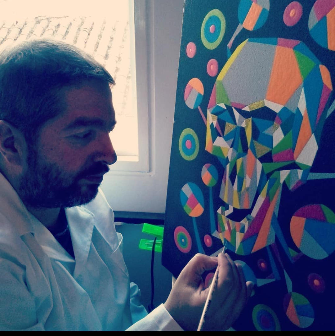 Profesor de pintura coloreando un cuadro.