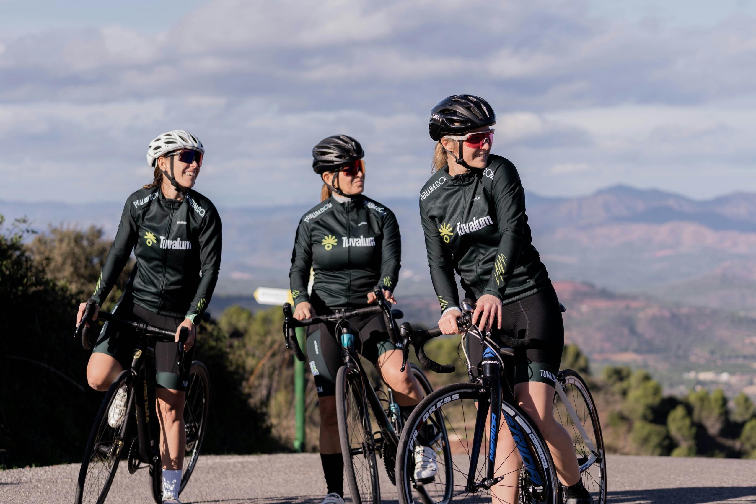 Imagen de tres mujeres ciclistas profesionales en la carretera