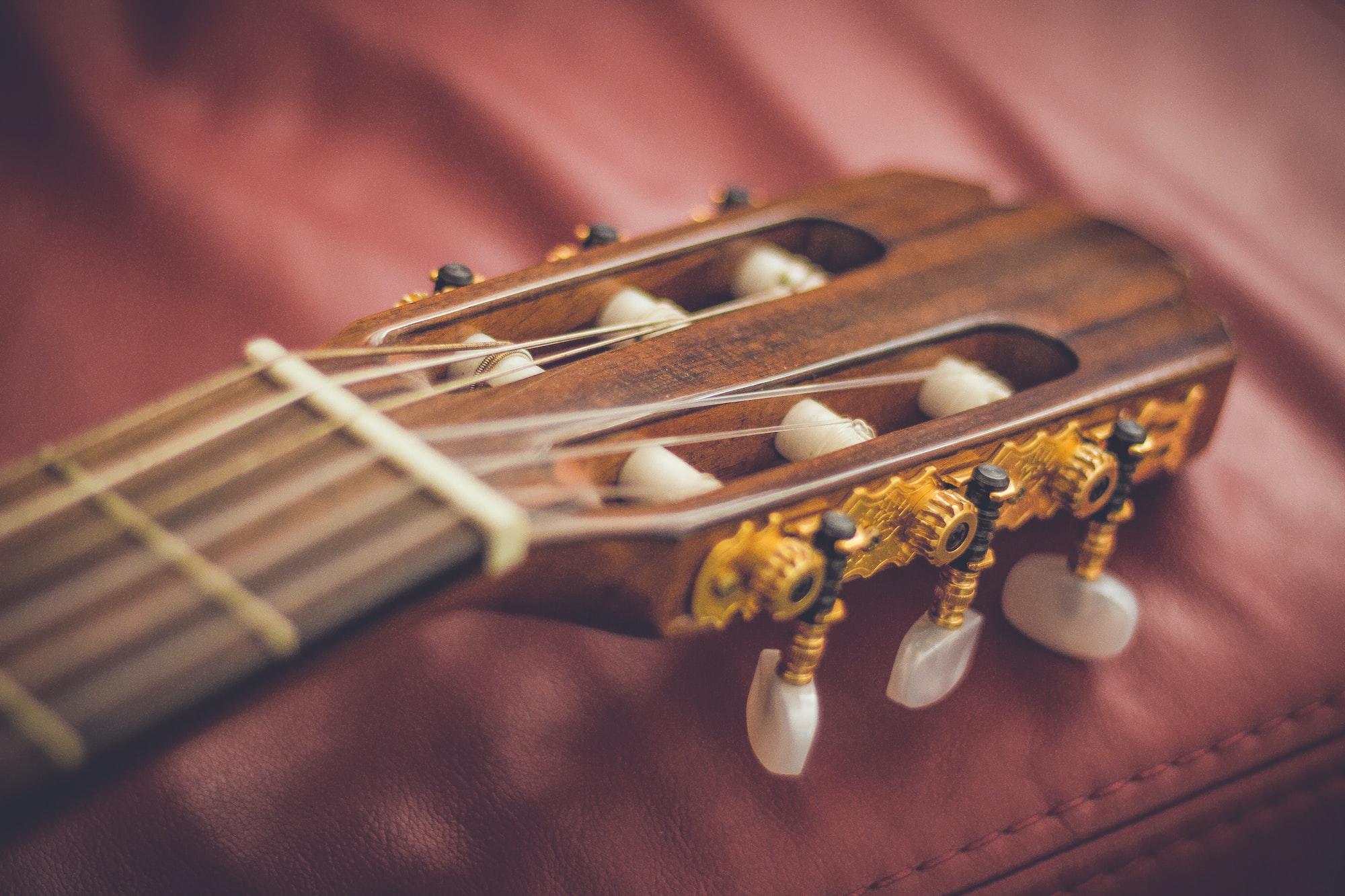 Auf dem Bild sieht man die durchbrochene Kopfplatte einer klassischen Gitarre.