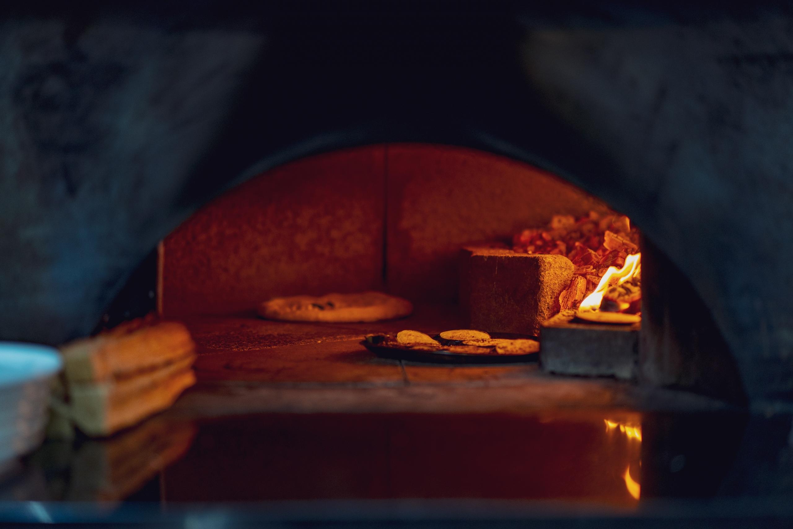 Das Innere eines Pizza-Steinofens in Betrieb - Du kannst dir auch selbst glutenfreie Pizza machen