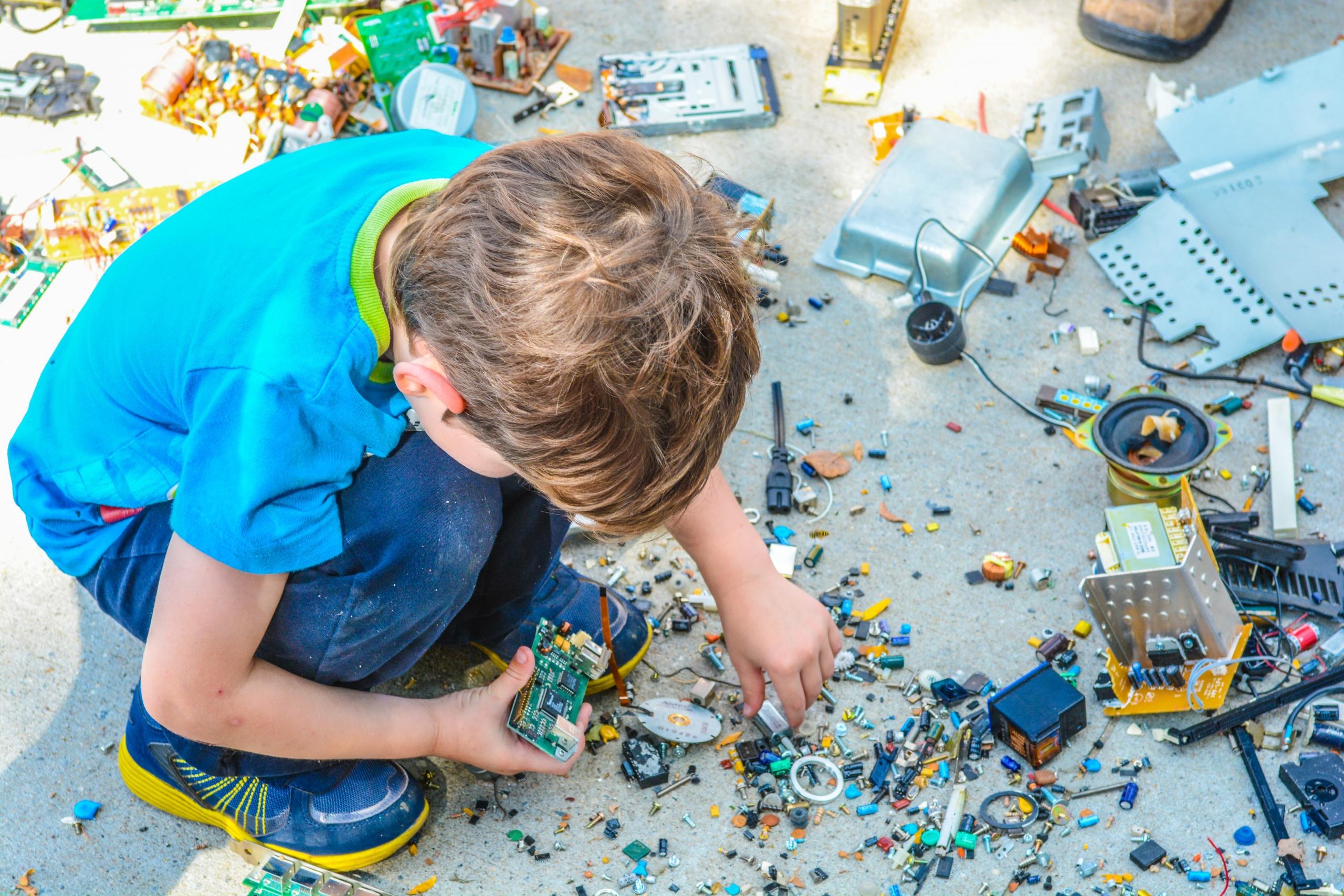 Ein Junge hält technisches Spielzeug in der Hand.