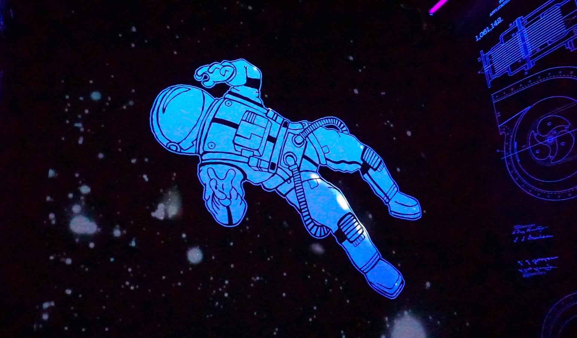 Eine Zeichnung zeigt einen Astronaut und der schwebt im Weltraum vor den Sternen.