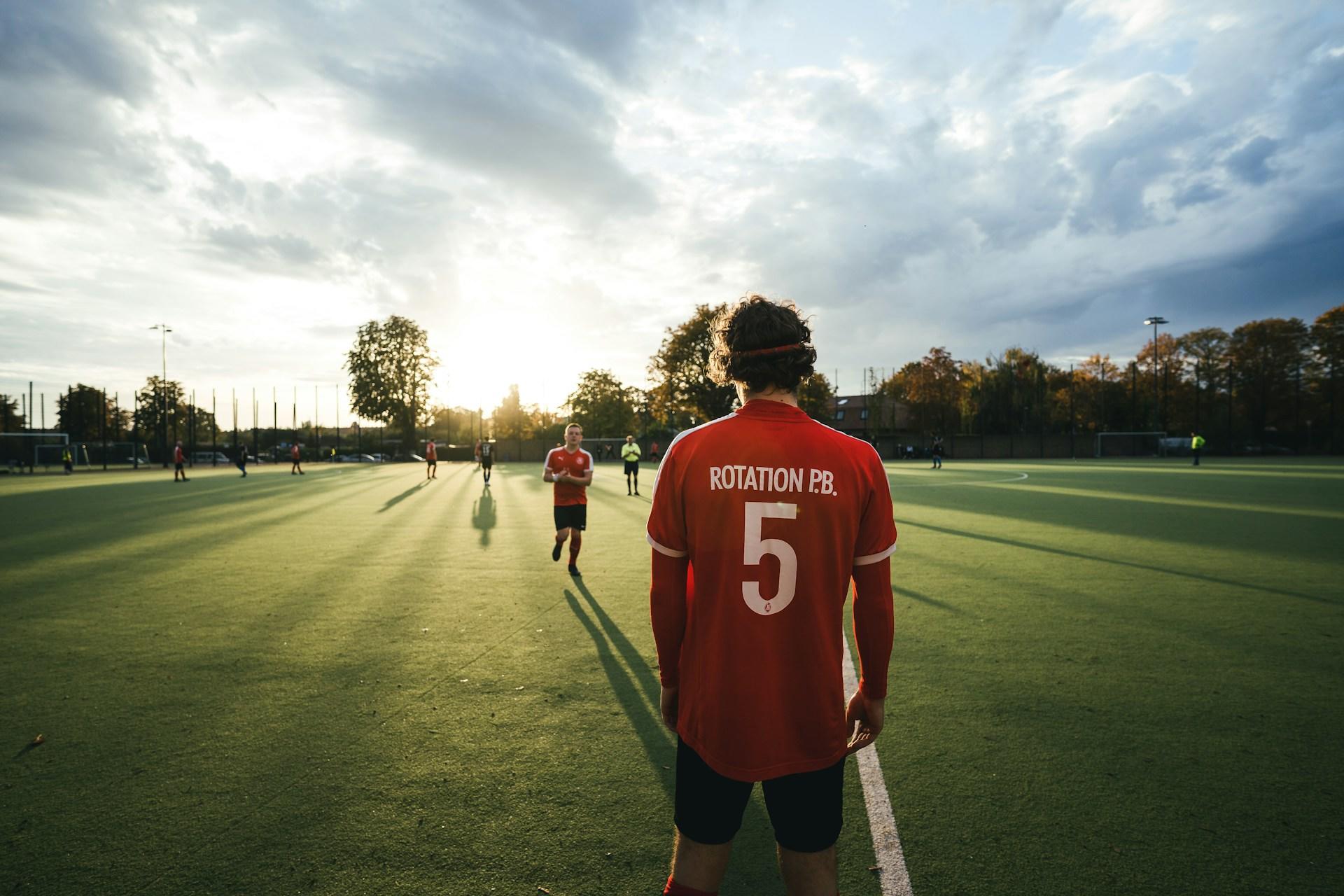 Fussballspieler im Trikot am Rand des Rasens.
