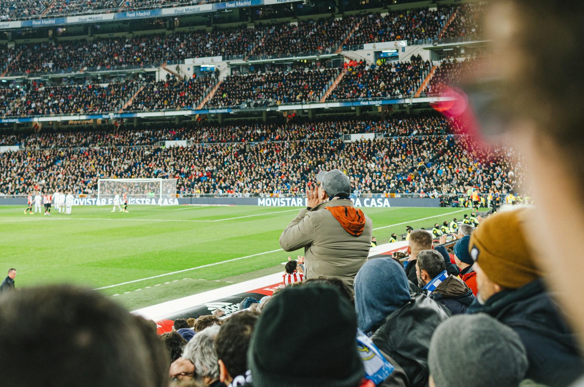 Volles Fussballstadion mit Fans auf den Rängen.