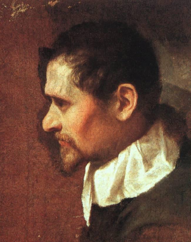 Retrato de perfil de Annibale Carracci con cabello castaño y barba sobre un fondo oscuro, vestido con una camisa blanca con cuello. La expresión es pensativa.