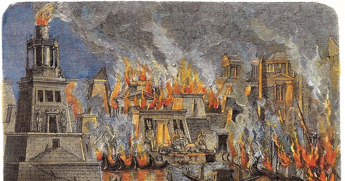 Ilustración de una ciudad en llamas, con estructuras antiguas envueltas en llamas y humo. Un faro se alza en primer plano, creando una escena de caos y urgencia.