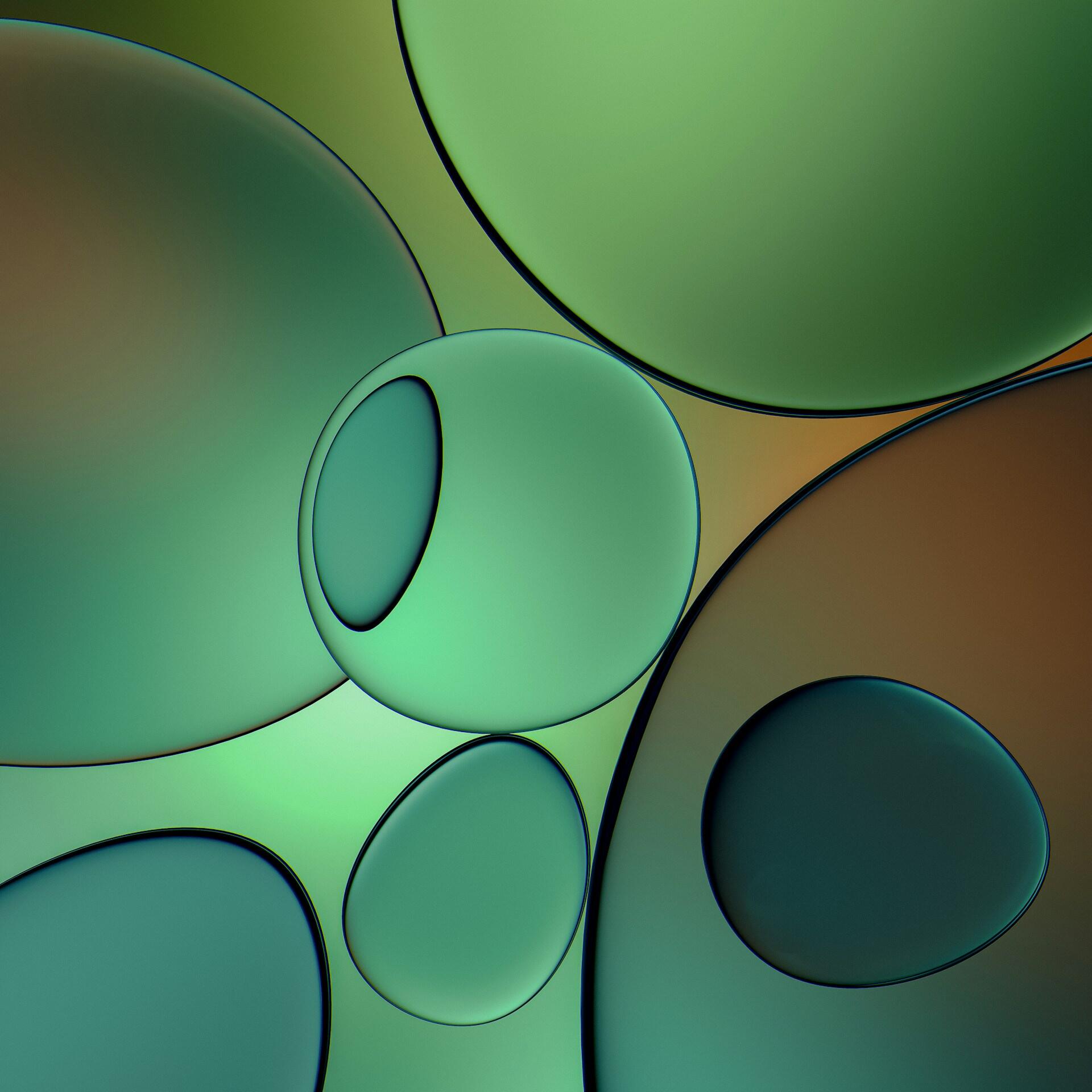 Imagen abstracta en la que aparecen burbujas translúcidas de color verde y marrón superpuestas sobre un fondo con degradado. Las suaves curvas crean una sensación relajante y orgánica.