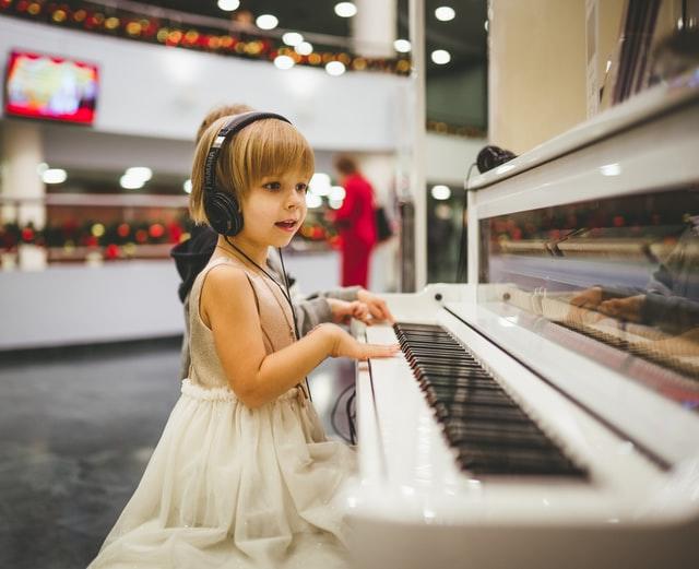 niña tocando las teclas del piano