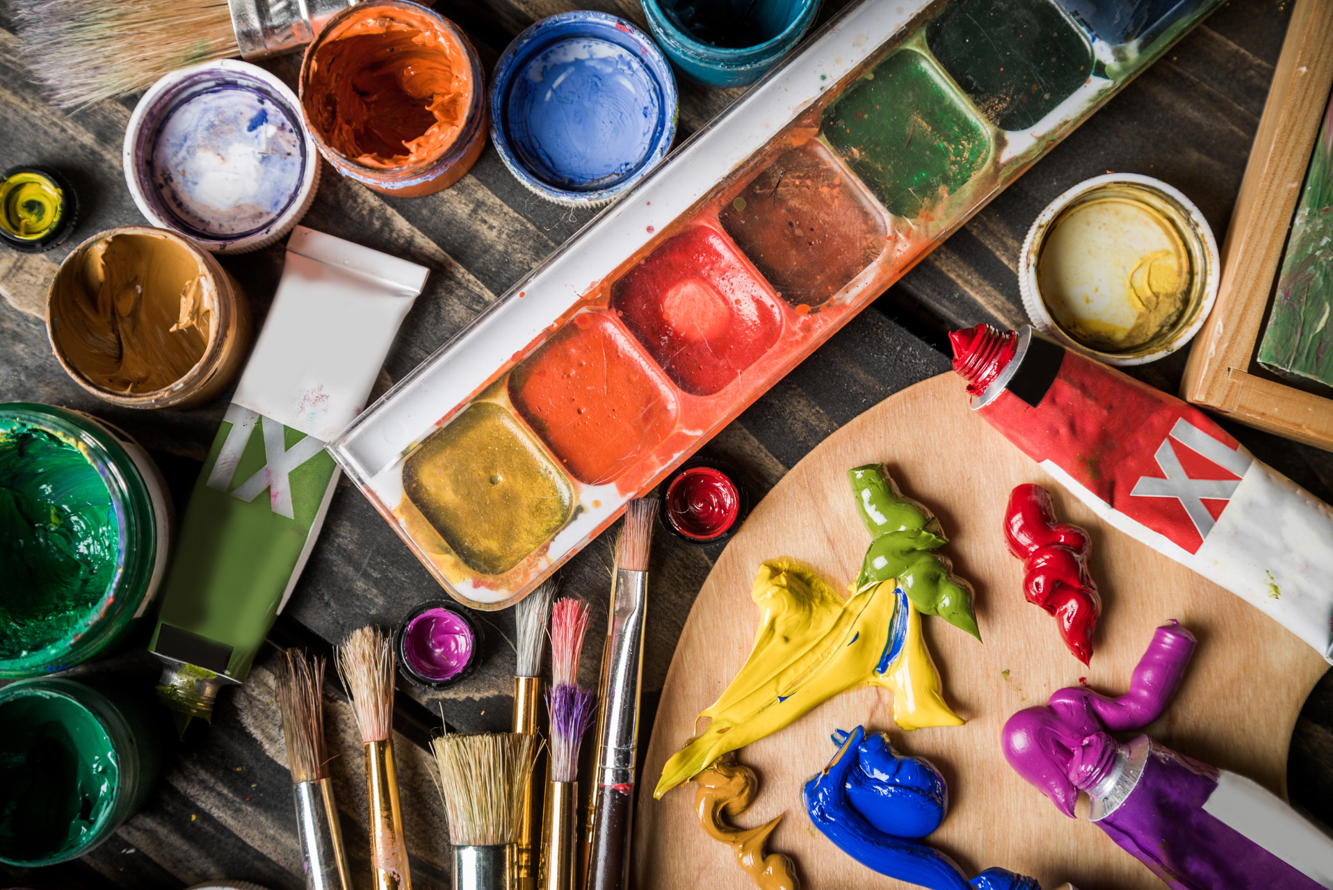 acrílicos de diferentes colores junto con pinceles y mezclador