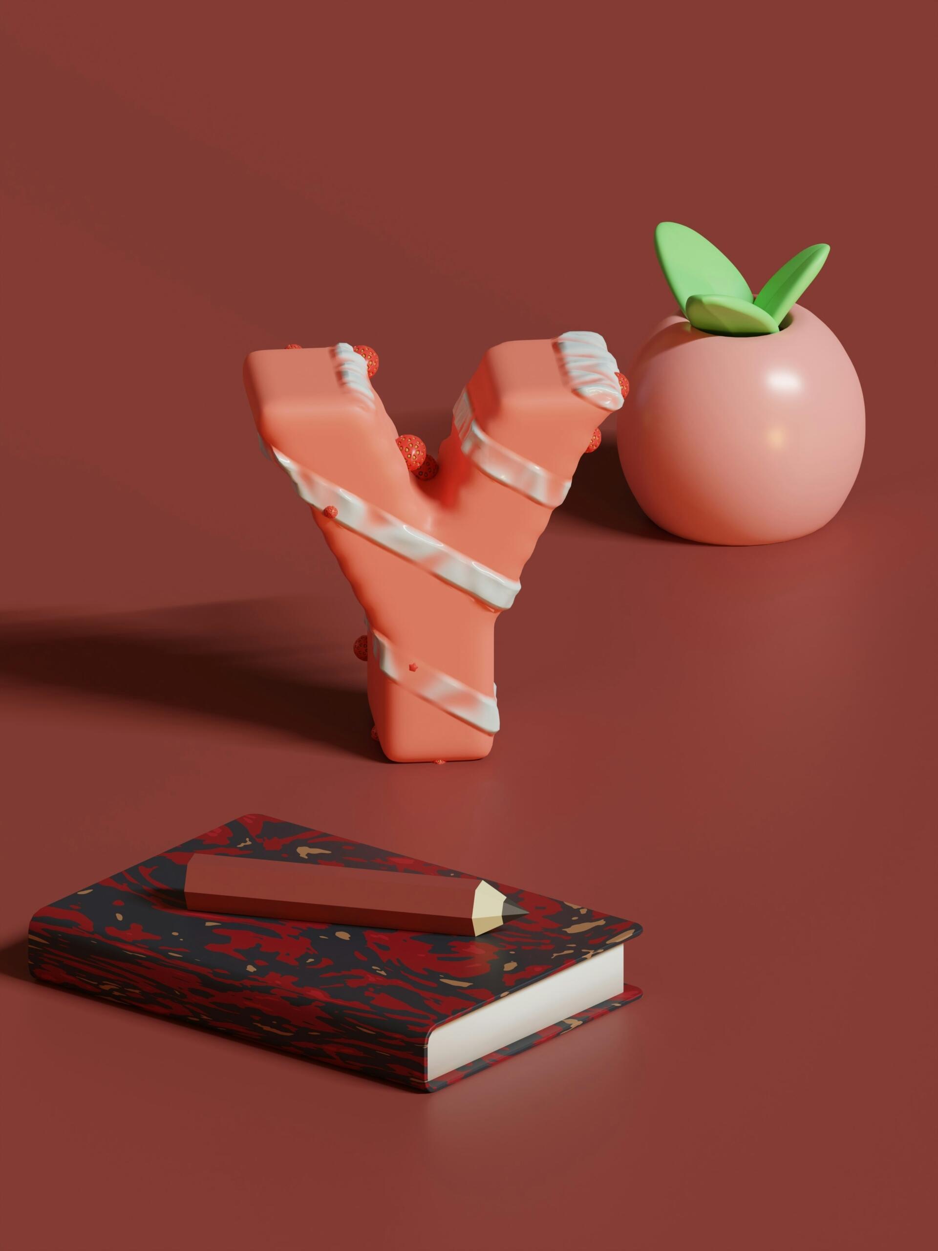 Escena renderizada en 3D con una letra «Y» rosa, un objeto redondo parecido a un melocotón con hojas verdes y un cuaderno jaspeado con un lápiz.