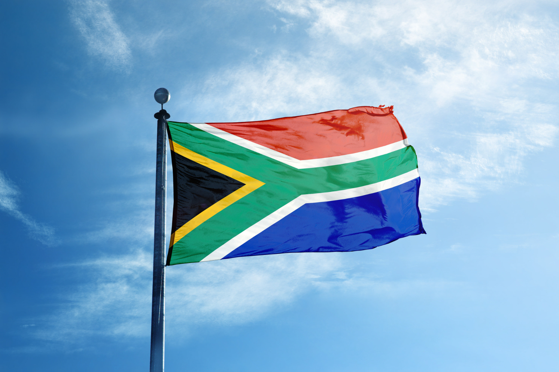 Bandera de Sudáfrica con una forma en "Y" y varios colores: verde, amarillo, azul, rojo y negro.