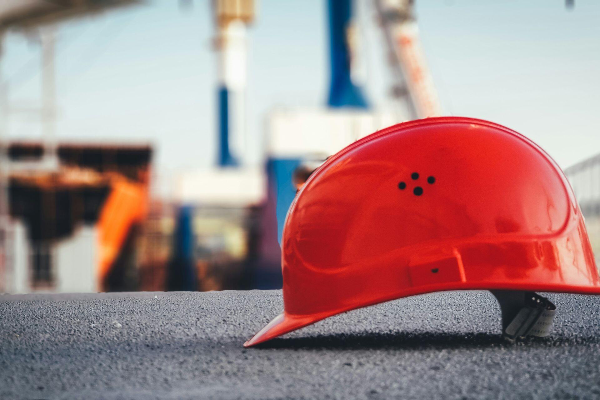 Un casco de seguridad rojo colocado en el suelo.
