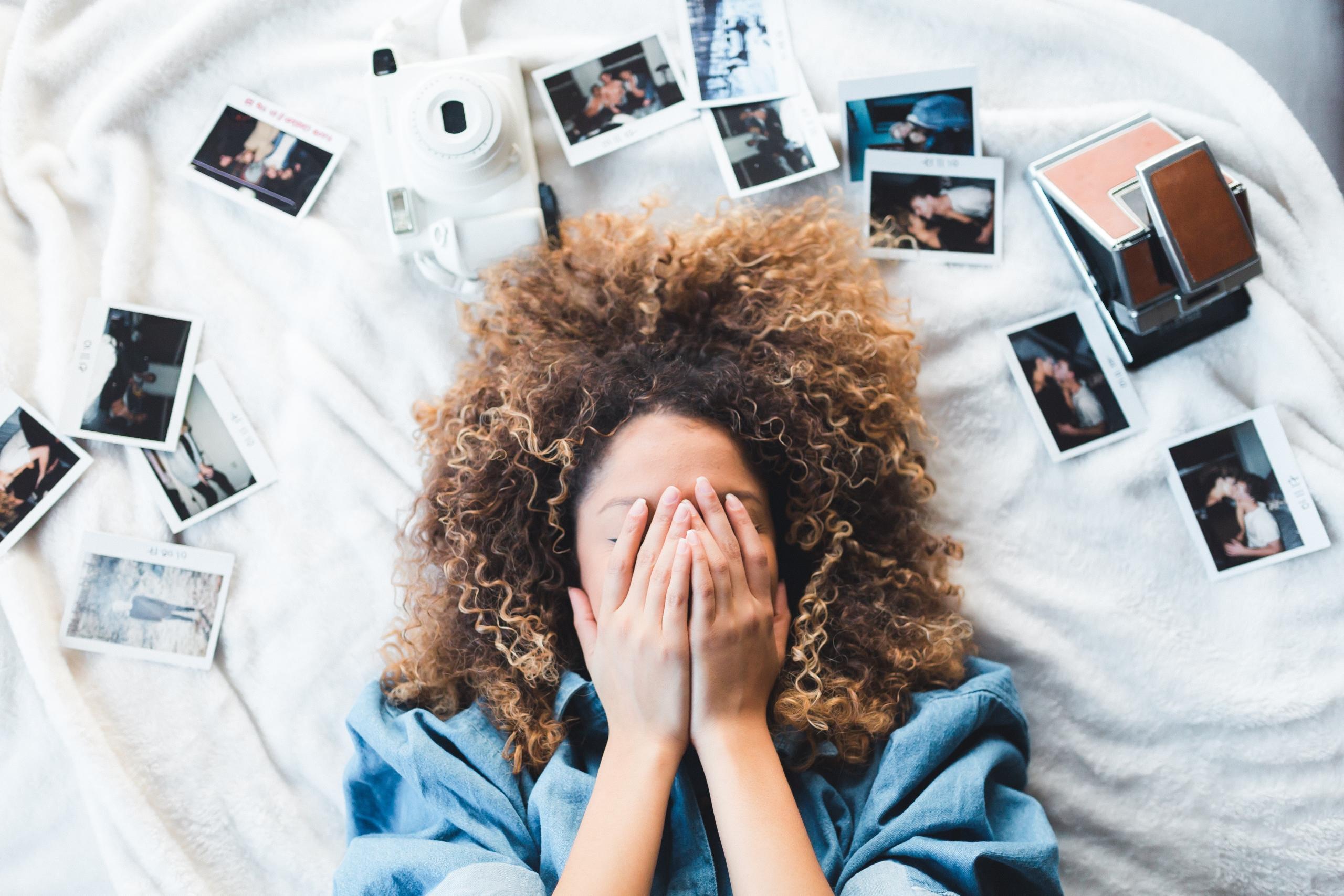 woman on a bed with photos