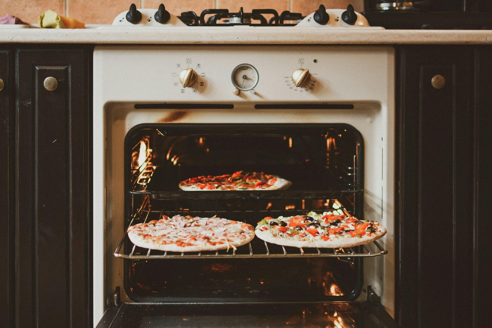 Kolme pizzaa uunissa