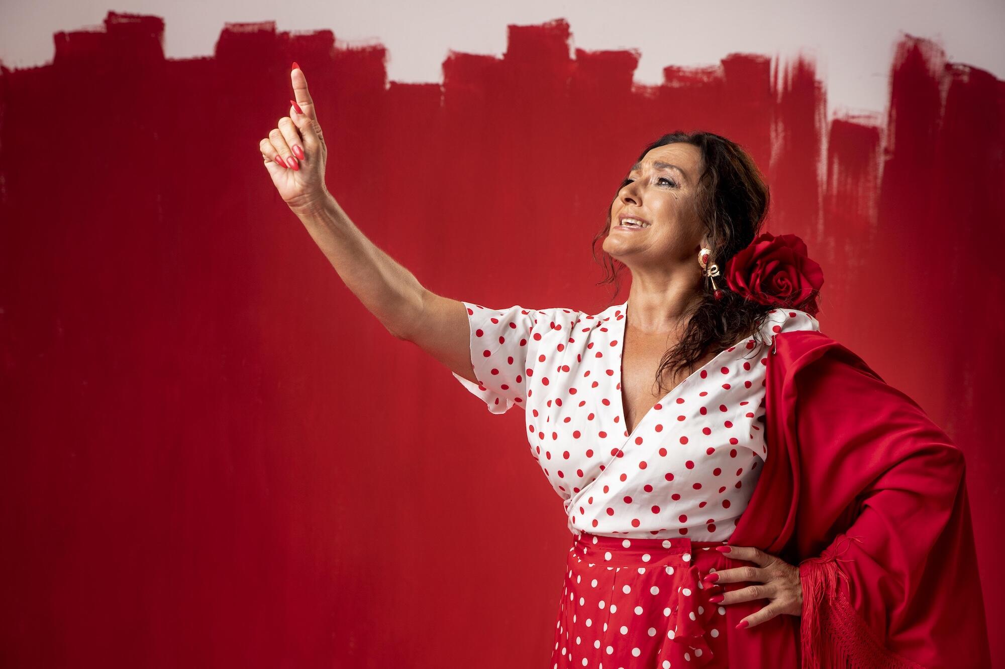 Une danseuse de flamenco devant un mur rouge