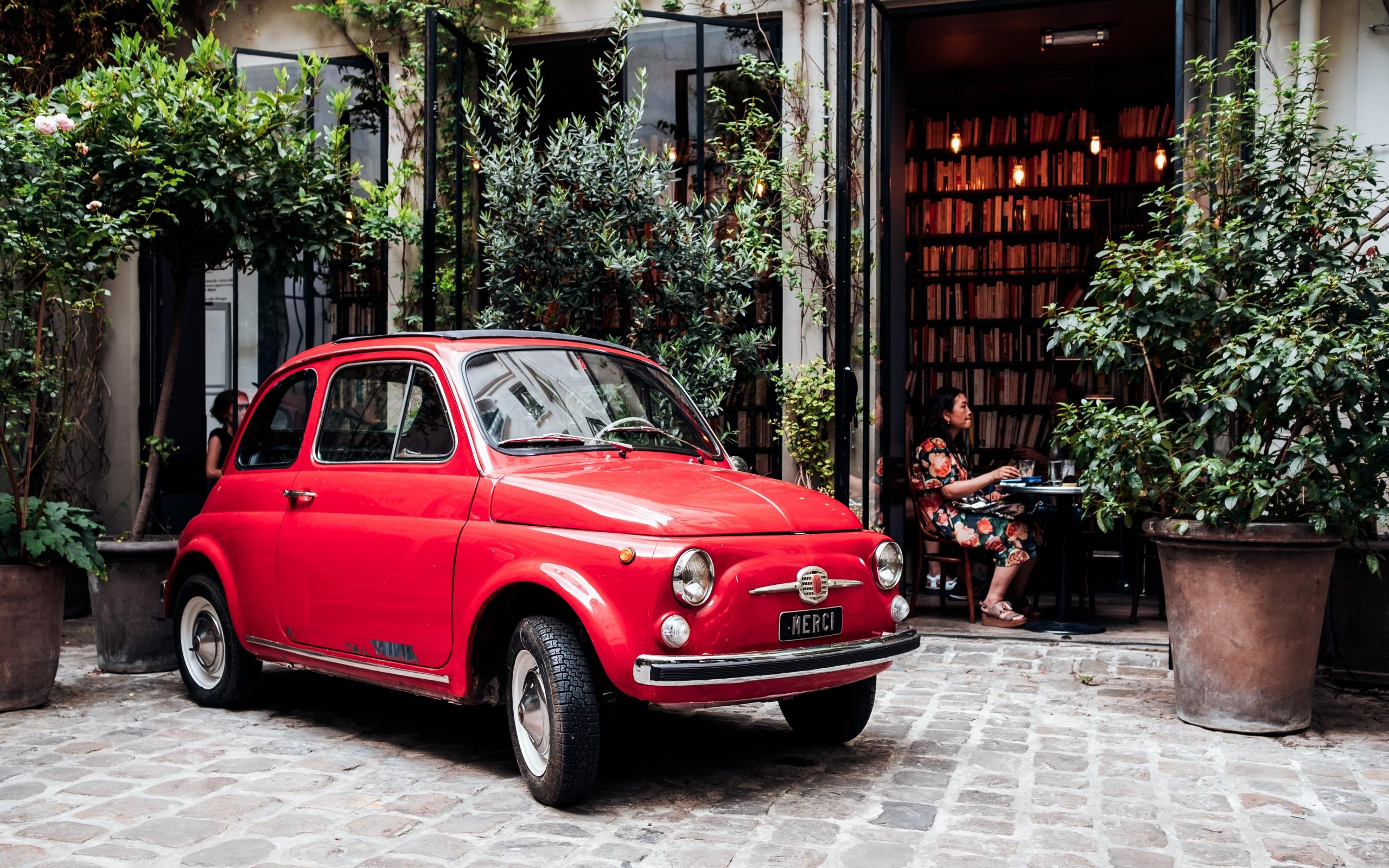 L'iconique petite voiture rouge devant chez Merci Paris.