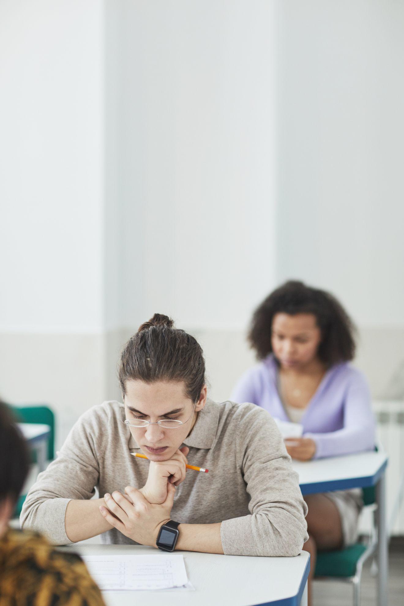 Des personnes en train de passer un examen écrit.