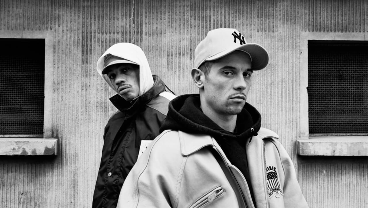 Kool Shen et Joey Starr sont vêtus d'une casquette et regardent vers la caméra.