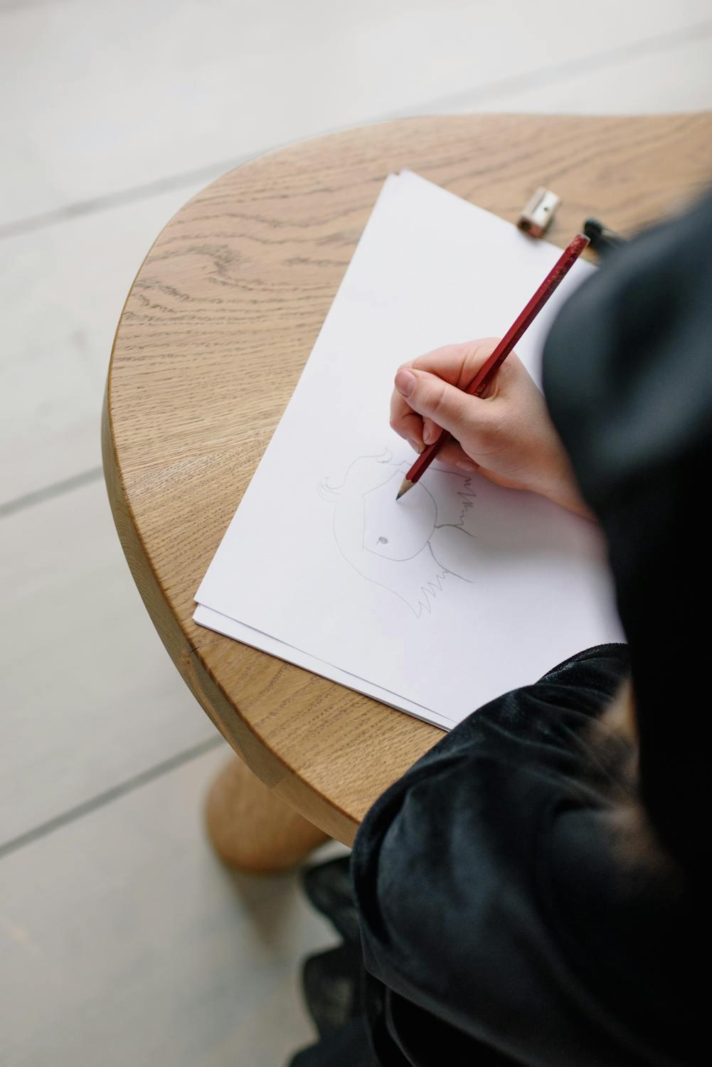 Une personne dessine le visage d'un personnage. 
