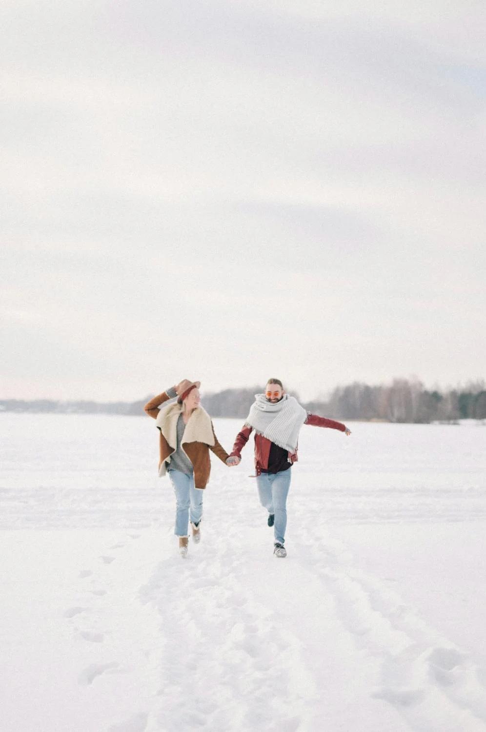 Deux personnes courent dans la neige.