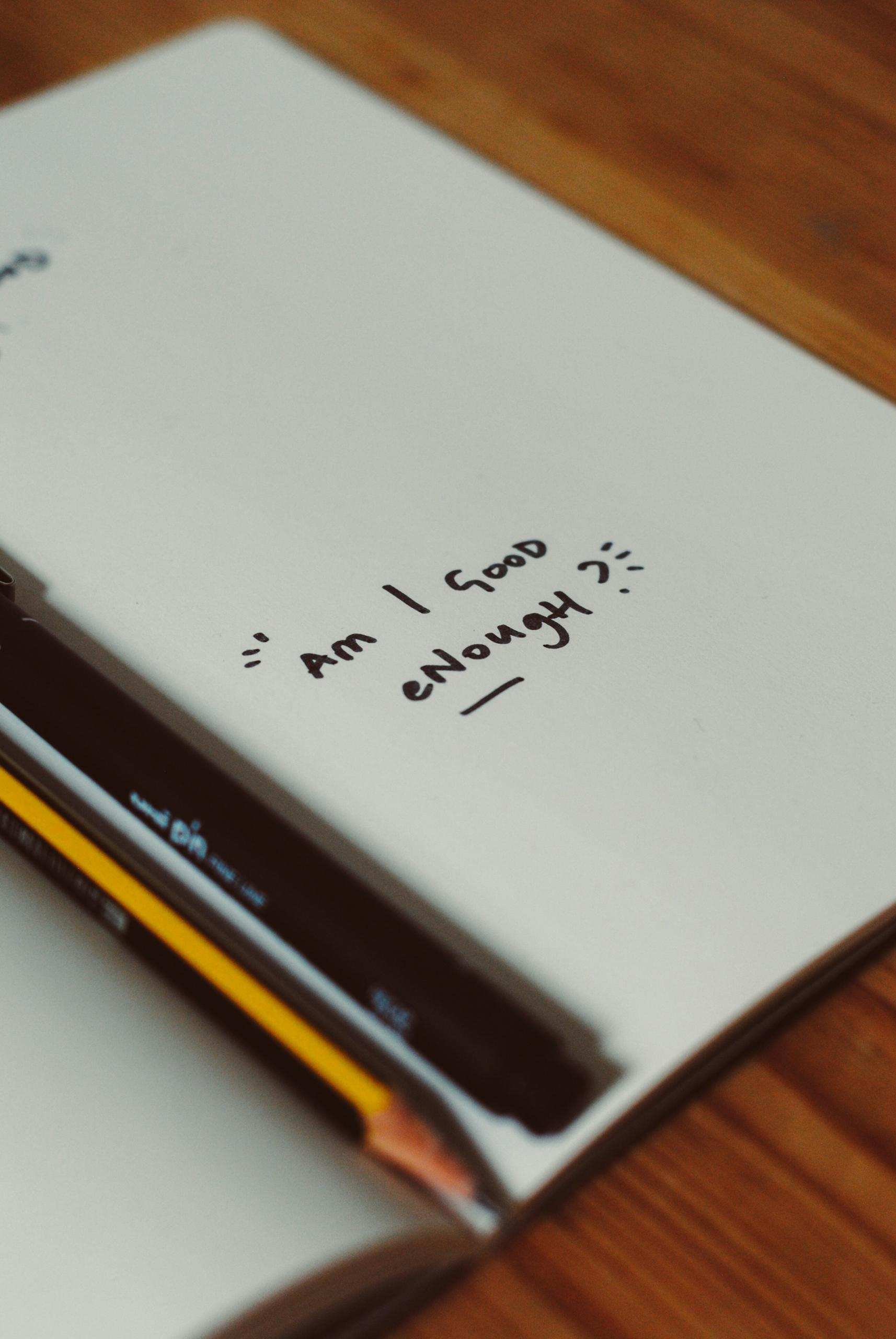 fiche avec une inscription "Am I Good Enough ?"
