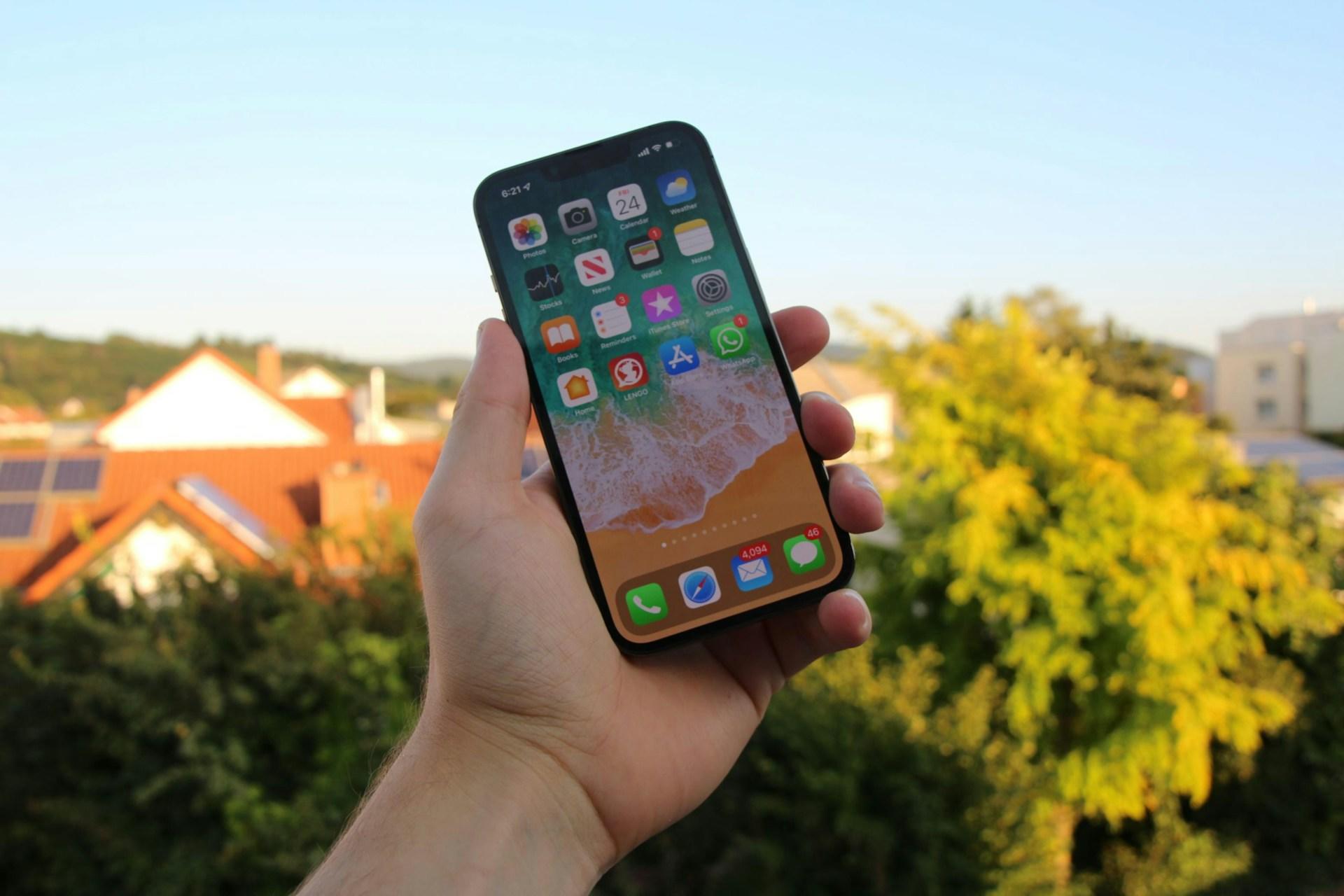 personne tenant un téléphone dans sa main