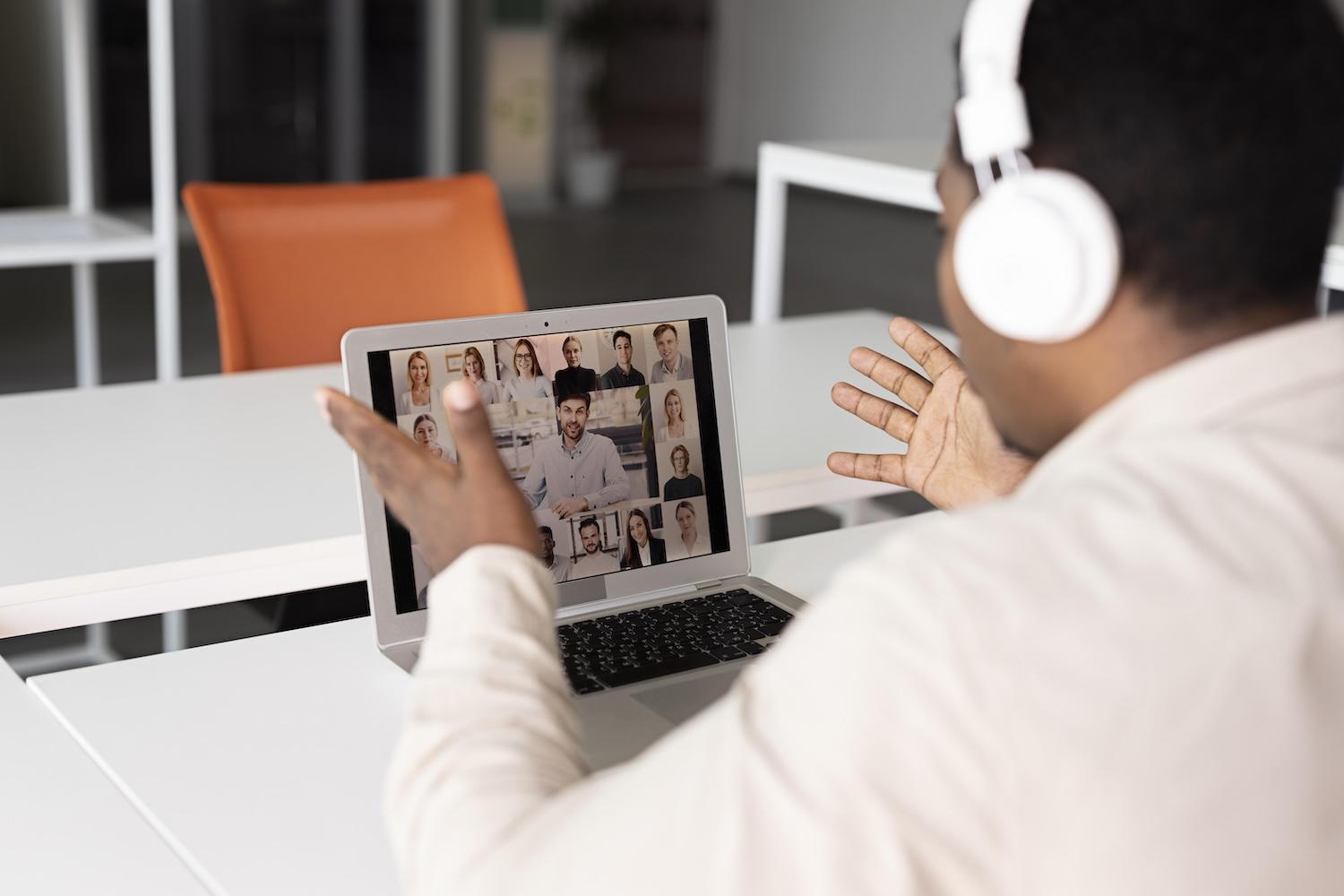 Un élève suit un cours en visio sur son ordinateur.