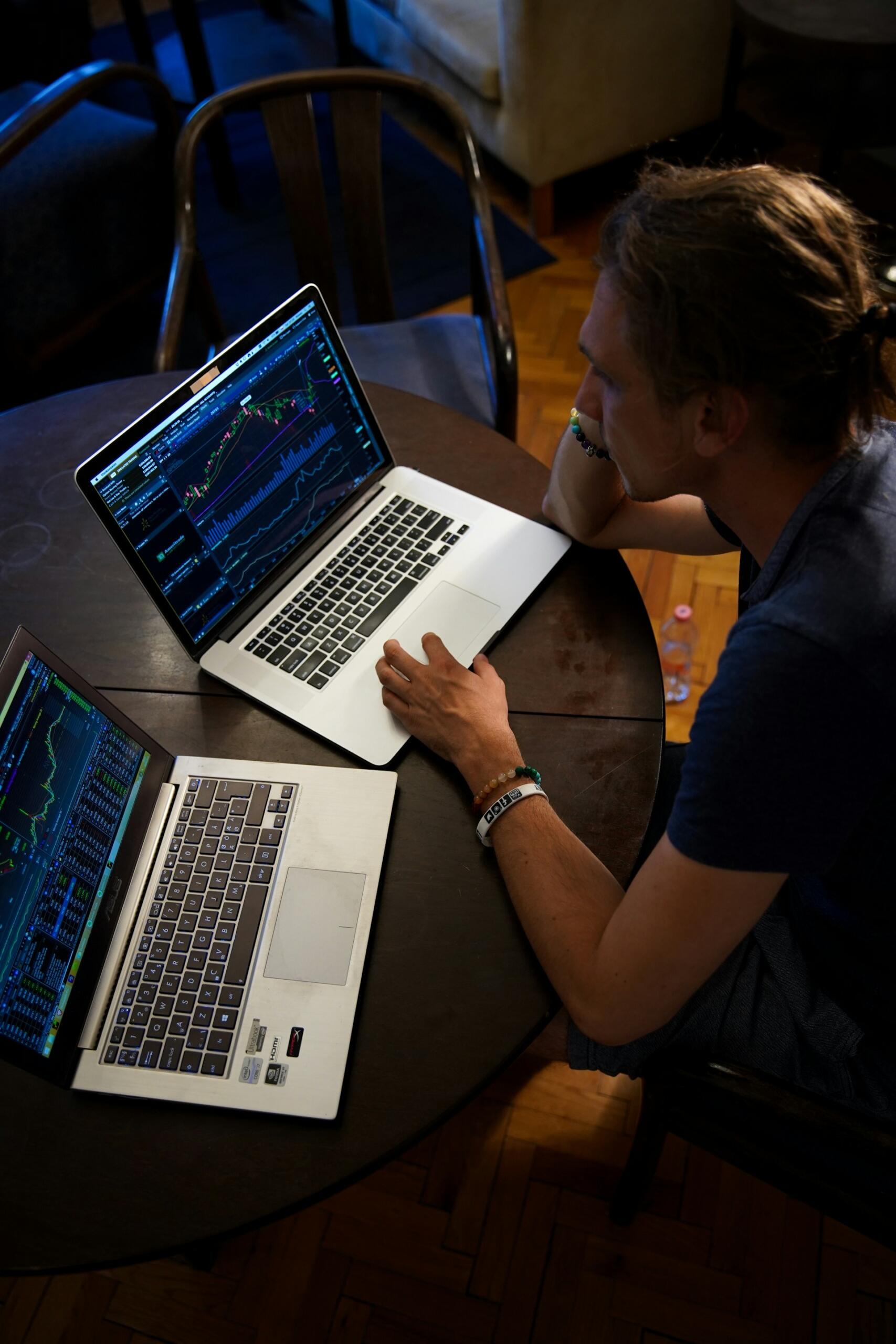 homme devant ses ordinateurs de trading