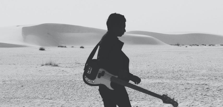 a man with a guitar on a beach