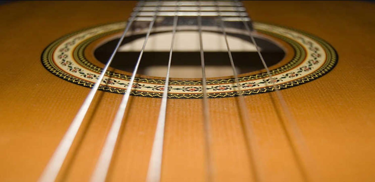 the strings and soundhole of an acoustic gutiar