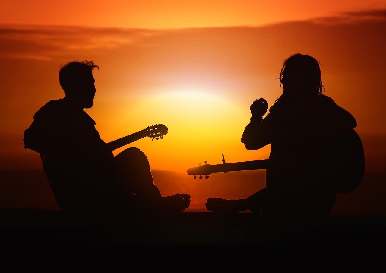 Two guitarists at sunset