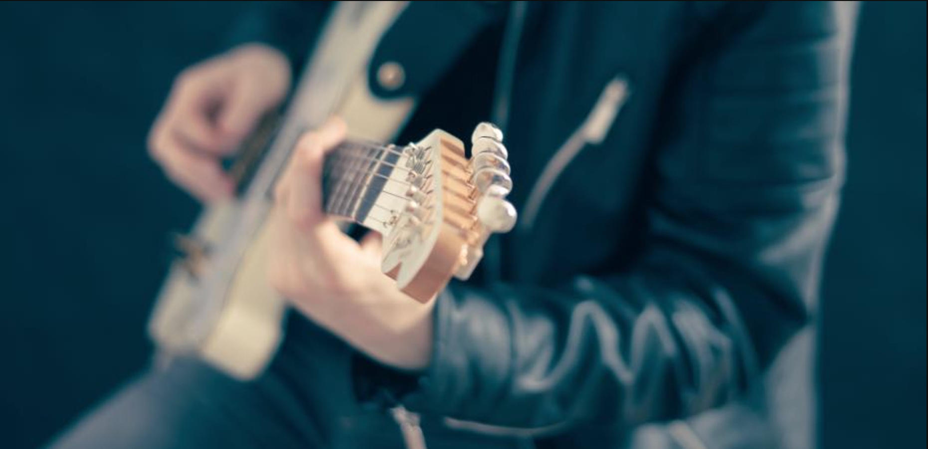 A man playing guitar chords
