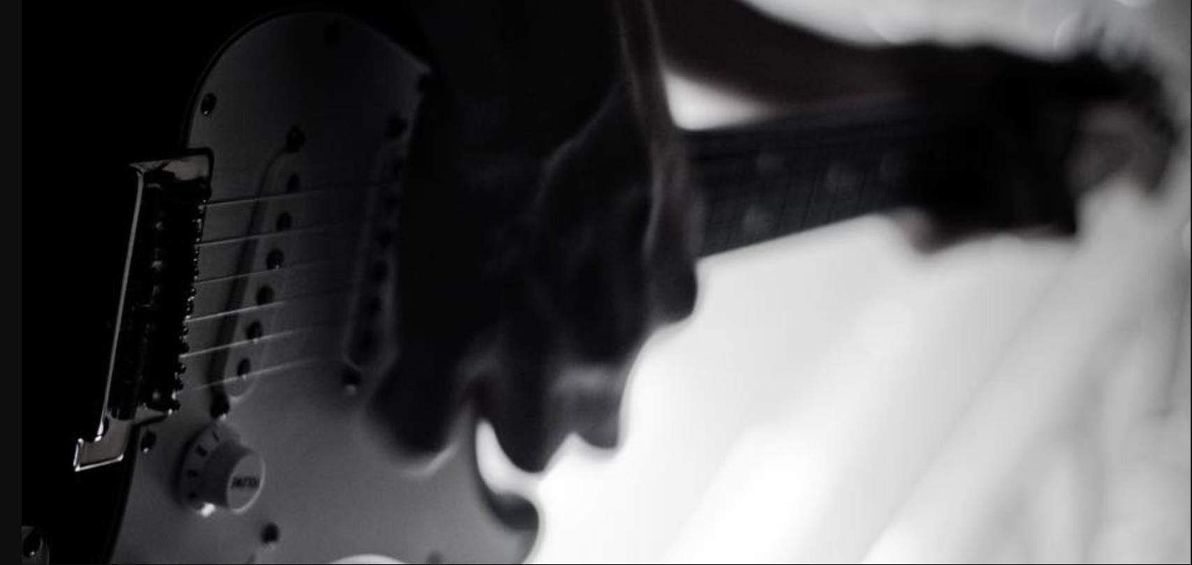 Silhouette of a guitarist playing guitar.