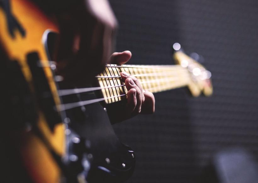 A guitarist performs onstage.