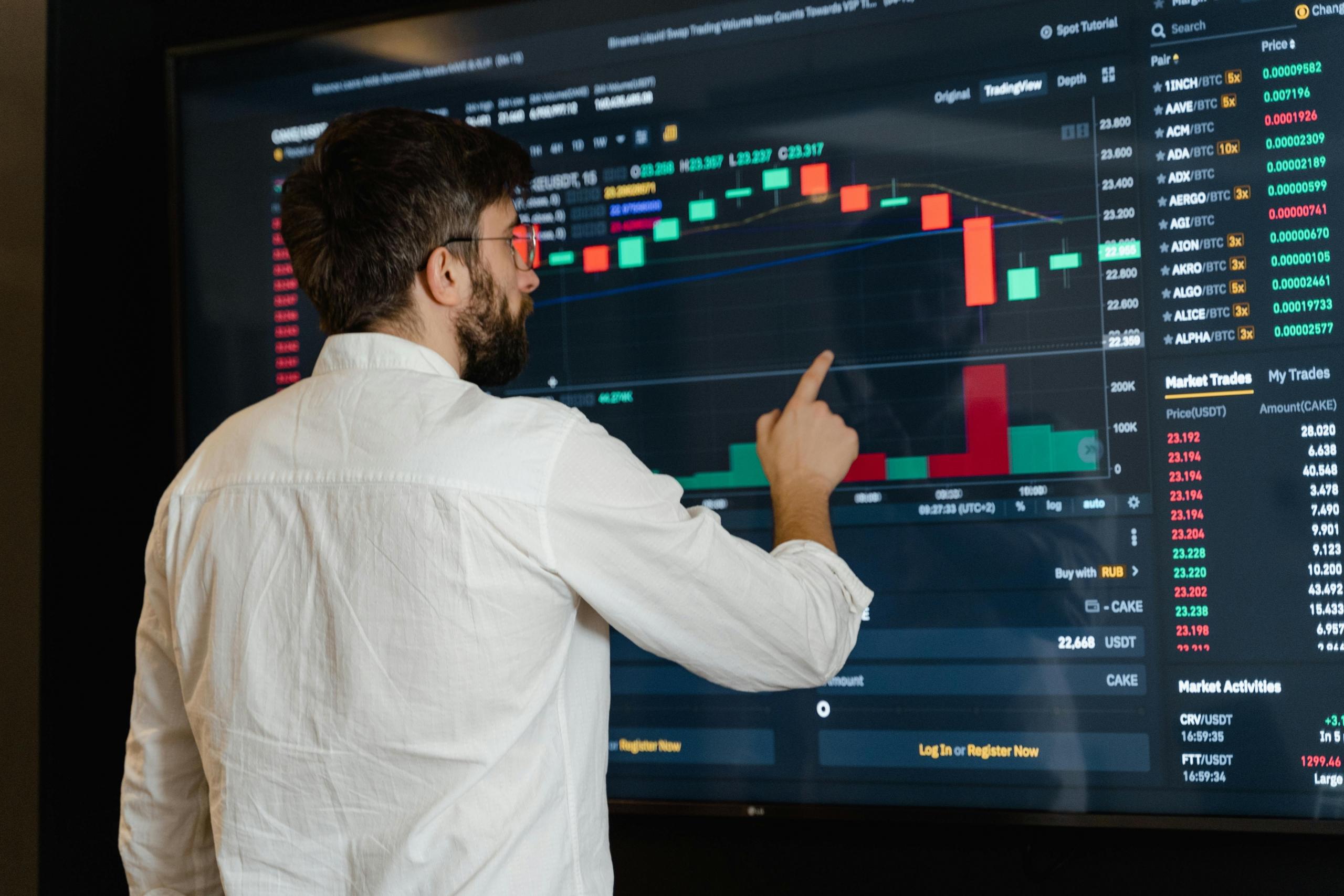 A man pointing on the board with data