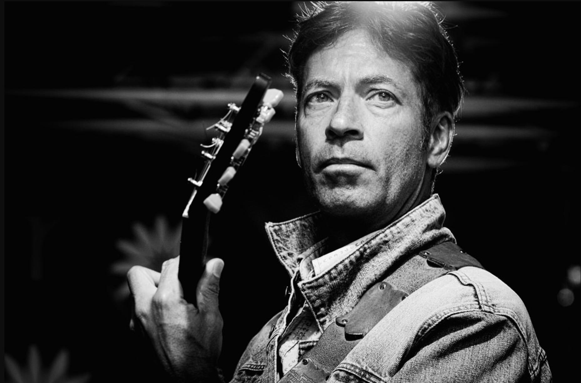 A man playing the guitar.