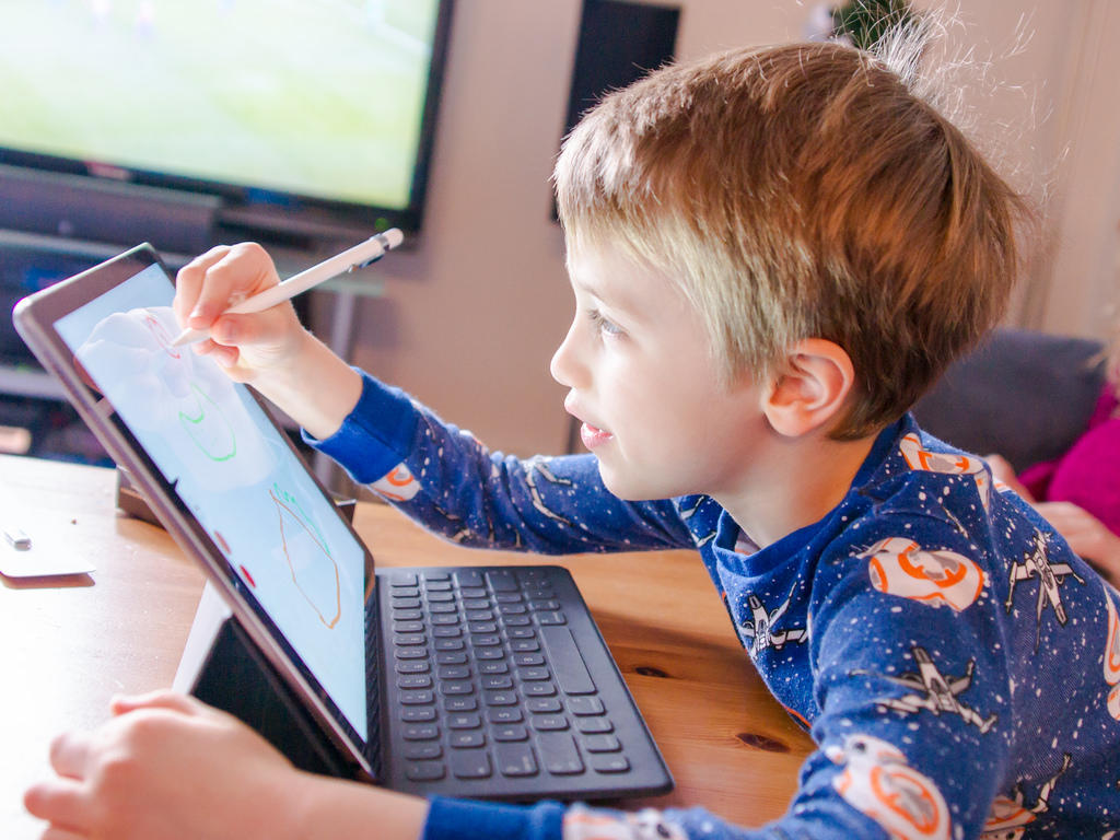 Using a tablet to learn how to draw means children will never run out of paper!