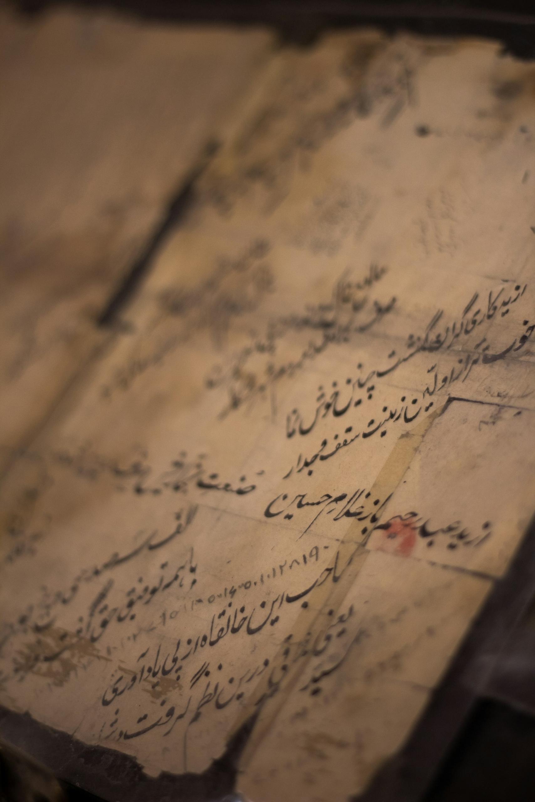 Arabic script written on a piece of paper
