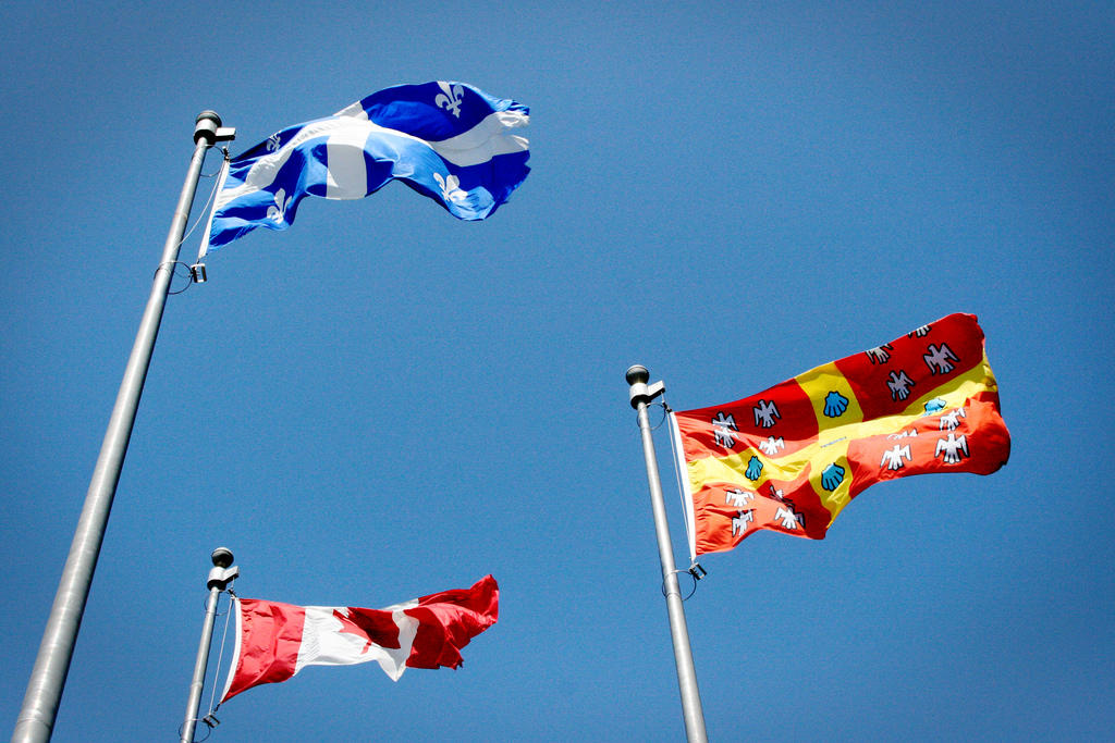 Quebecs flag shows its French origins.