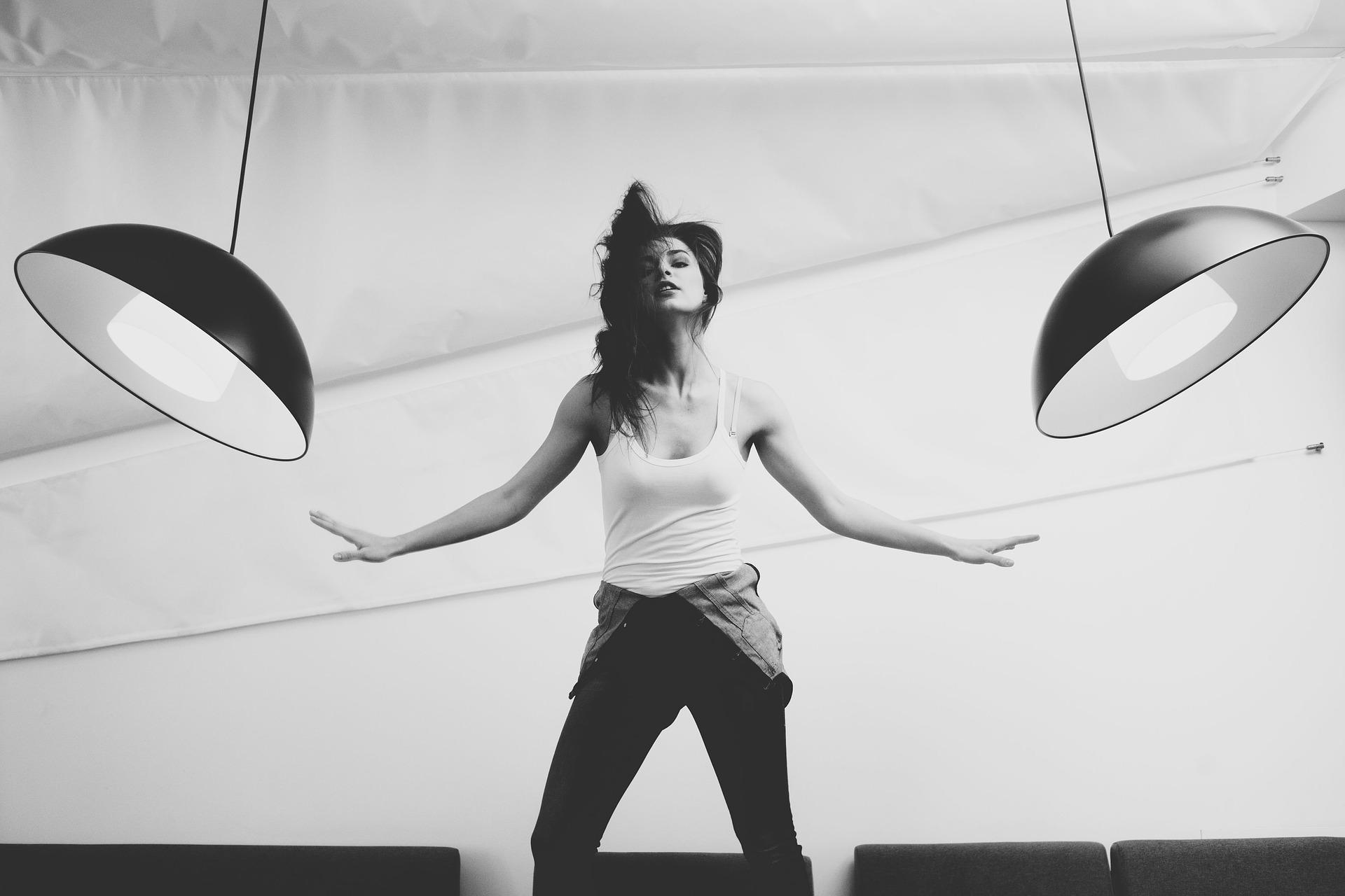 A model posing between two swinging lights.